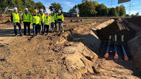 Delegation, bestehend aus 11 Personen, auf einer Baustelle. 
